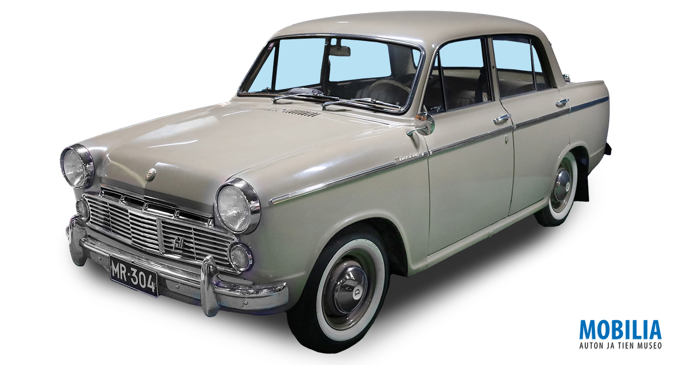 Vuosimallin 1963 vaaleanharmaa Datsun Bluebird kuvattuna etuviistosta.